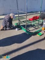 Na zdjęciu widoczni są pracownicy BOSIR podczas malowania wiaty stadionowej
